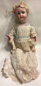 A large German porcelain headed doll.