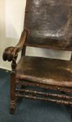 A good early leather back armchair with scroll handles to double stretcher base.