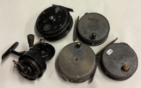 Three Hardy Brother fly fishing reels together with two others.