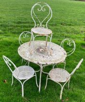 A painted garden table together with matching chairs.
