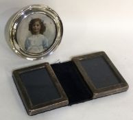 An unusual double silver picture frame together with one other.