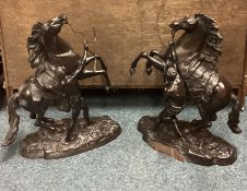 A good pair of large bronze figures of horses on rugged landscape.