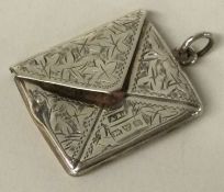CHESTER: A silver stamp case in the form of an envelope.
