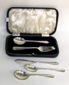 A boxed silver preserve spoon and fork together with a butter knife etc.