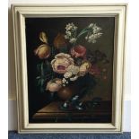 A framed canvas painting depicting still life with flowers.