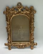 A small gilt picture frame with domed top.