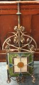 A wrought iron and stained glass lamp.