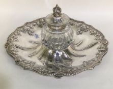A Victorian circular silver ink well with hinged lid.
