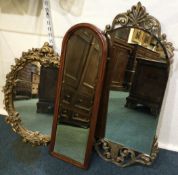 A group of three gilt framed mirrors.