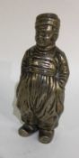 A heavy Continental silver pepper in the form of a boy with textured body.