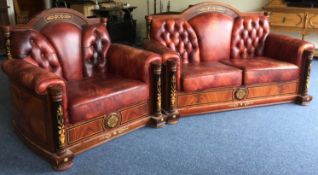 A good quality leather two piece settee suite with inlaid decoration.