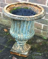 A wrought iron fluted garden planter.