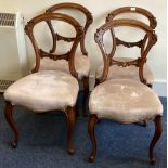 A set of four Victorian dining chairs of typical form with cabriole legs.