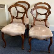 A set of four Victorian dining chairs of typical form with cabriole legs.