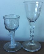 Two good Georgian air-twist glasses of typical form to pedestal base.