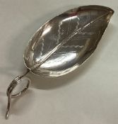 A Georgian bright-cut silver caddy spoon with leaf pattern.