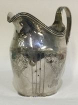 A heavy Georgian silver cream jug with scroll decoration.