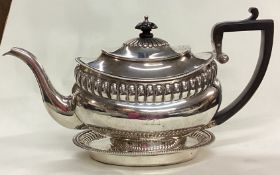A George III silver teapot on stand.
