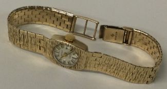 A heavy 9 carat lady's wristwatch with mesh strap.