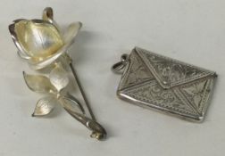 A Sterling silver stamp case together with a silver brooch.