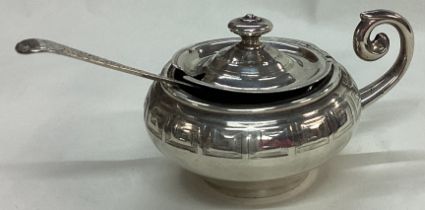 EDINBURGH: A Victorian silver engraved mustard pot and spoon.