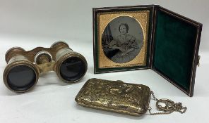 A small cased compact together with opera glasses etc.