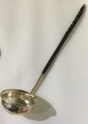 A Georgian silver mounted toddy ladle of typical form.