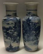 A good pair of Chinese blue and white vases decorated with buildings.