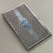 A silver engine turned card holder.