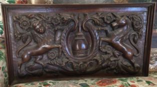 A large good quality mahogany shield with scroll decoration.