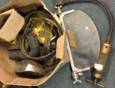 A box containing old vintage car parts and lamps.