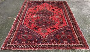 A small Oriental rug in red ground.