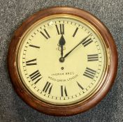 A mahogany cased wall clock of typical form.