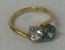 A good diamond and zircon two stone crossover ring in 18 carat gold setting.