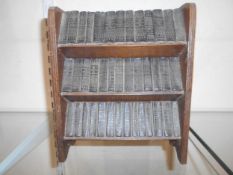 BOOKS: SHAKESPEARE: A miniature set of 40 volumes dated 1932 in custom made bookshelf.