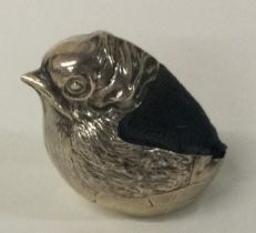A small silver pin cushion in the form of a chick with textured body.