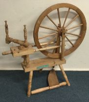 A stripped pine spinning wheel. Est. £30 - £50.