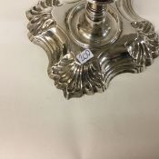 A fine pair of 18th Century George II cast silver candlesticks with shell borders.