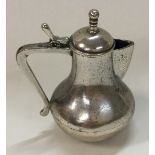 A heavy silver toy coffee pot.