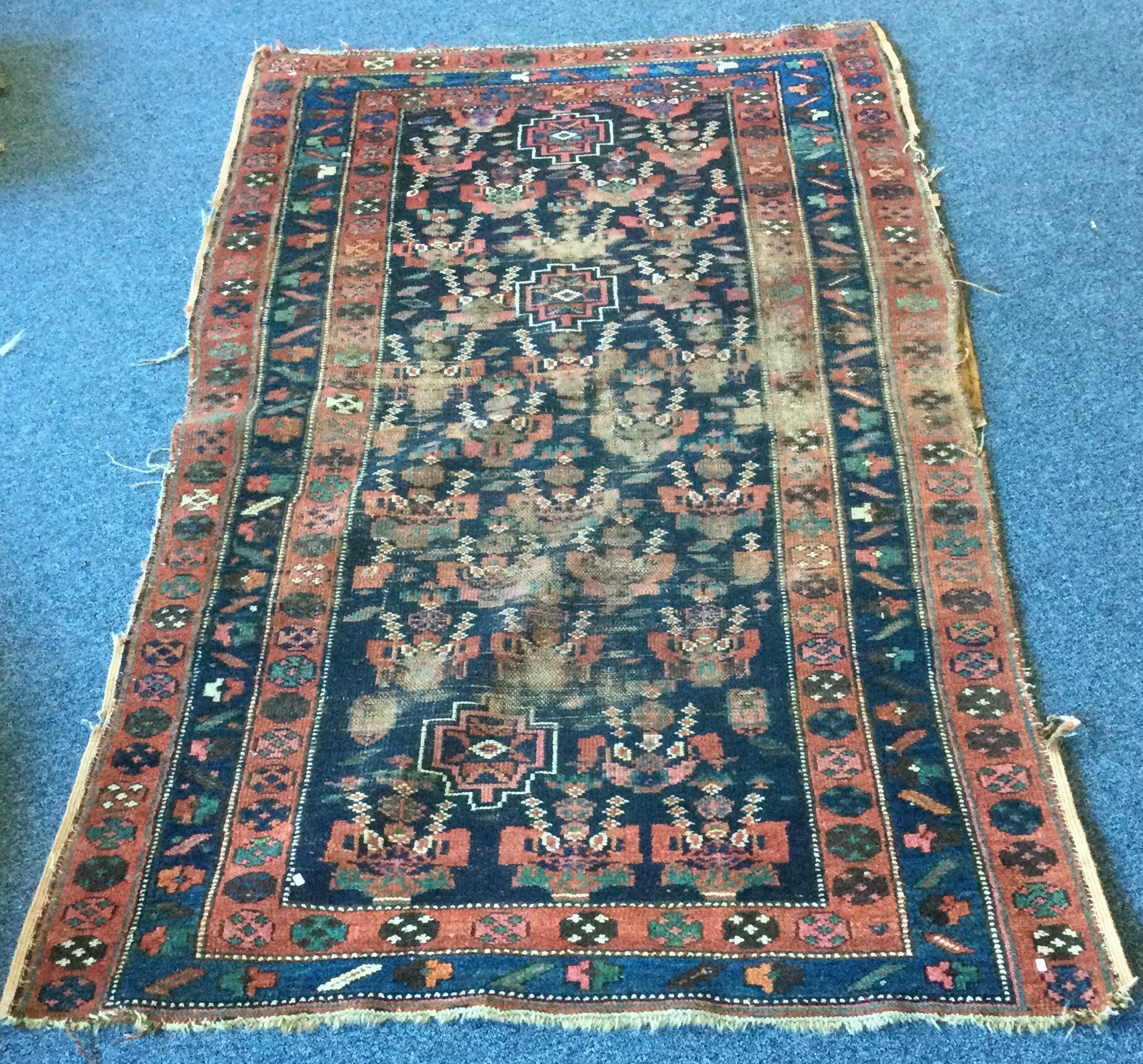 An old tapestry rug. Approx. 112 cms x 200 cms.