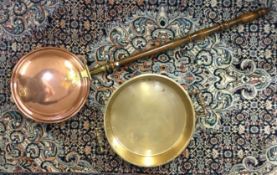 A heavy brass preserve pan together with a copper bed warmer.