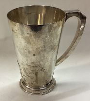 An Art Deco silver pint mug.