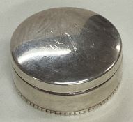 A silver box with screw top lid corn embossed with corn.