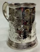 A clean George III chased silver tankard.