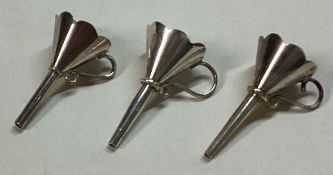 A good group of three English silver toy wine funnels.