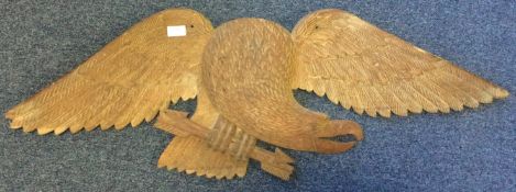 A large Continental wooden panel depicting an eagle with outstretched wings.