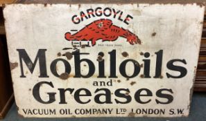 A large "Gargoyle Mobiloils and Greases" enamel sign.