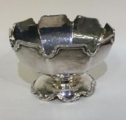 A heavy shaped silver sugar bowl.