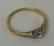 A small diamond single stone ring in 18 carat gold mount.