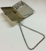 A heavy silver combination double sovereign case / compact / cigarette case on suspension chain.
